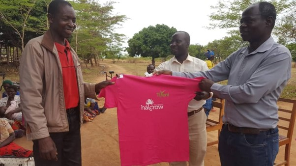 Farmers receive new T-shirts during a distribution ceremony